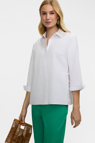 Angled front view of the Beatrice Pearl Stretch Matte Sateen 3/4 Sleeve Shirt
worn untucked and showing off the turnback cuffs #color_white