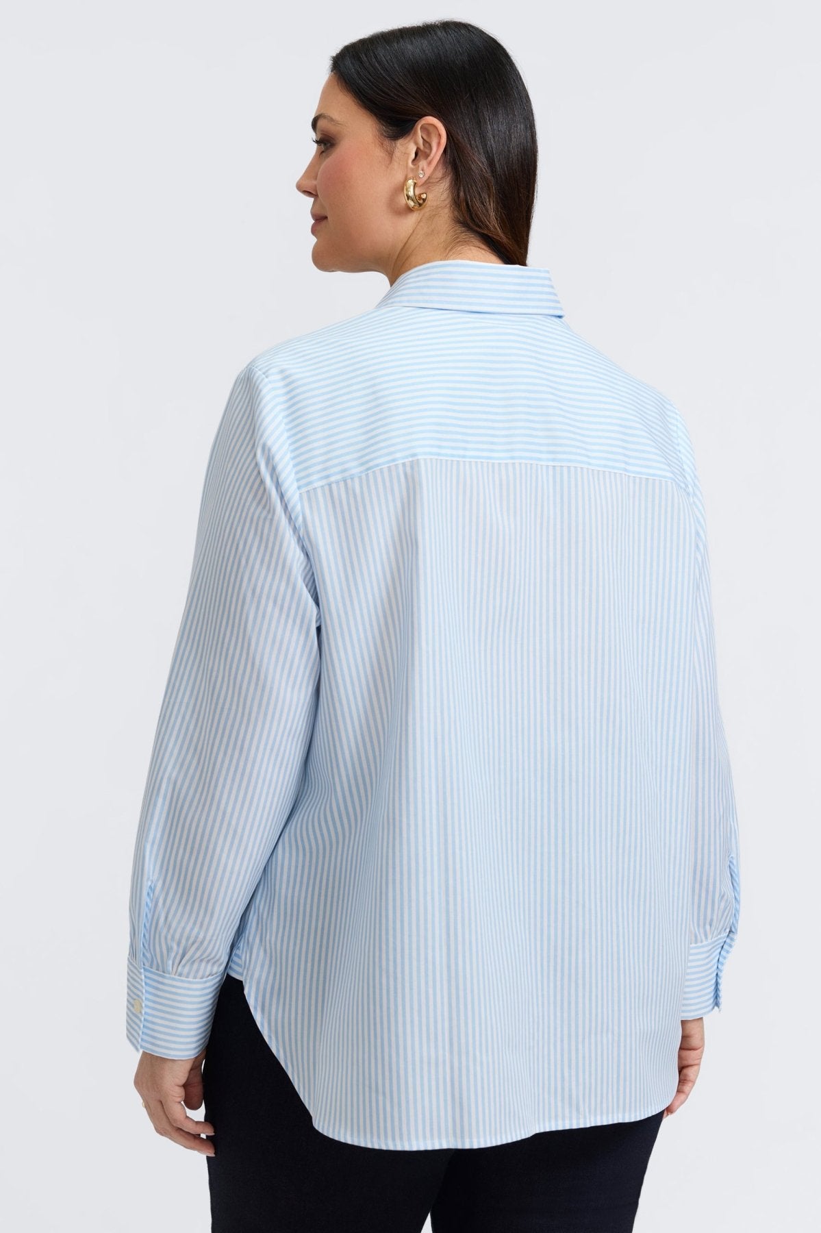 Plus-size woman in a blue floral stripe button-down from Foxcroft, offering cheerful sophistication with breathable ease. (1)