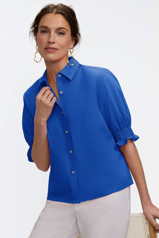 Front view of model wearing the Vivienne Stretch Matte Sateen Elbow Sleeve Shirt with one hand on the collar #color_deep sea