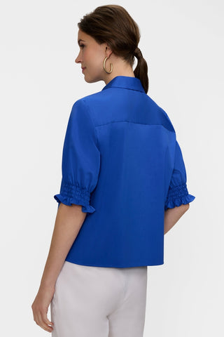 Angled back view of a model wearing the Vivienne Stretch Matte Sateen Elbow Sleeve Shirt #color_deep sea