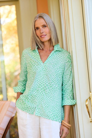 Woman in Foxcroft Agnes linen giraffe print shirt in Green, breathable fabric with chic detail