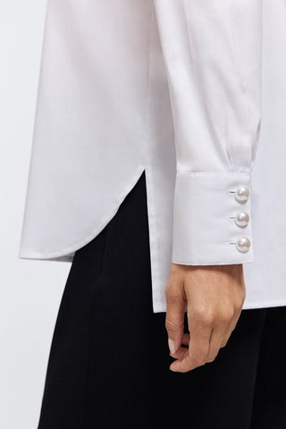 Close up of triple-button cuffs with stunning pearls on the Pearl Stretch Matte Sateen Long Sleeve Shirt #color_white