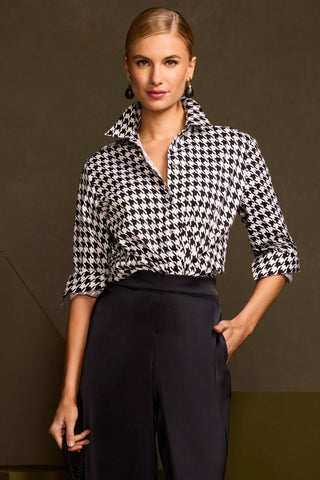Front view of model wearing the Meghan Classic Houndstooth Long Sleeve Shirt
tucked into a pair of black pants with the collar popped and sleeves rolled to the elbows 