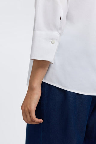Zoomed in view of the Mary No Iron Stretch 3/4 Sleeve Shirt showing the 3/4 sleeve length and the shell buttoned cuff #color_white