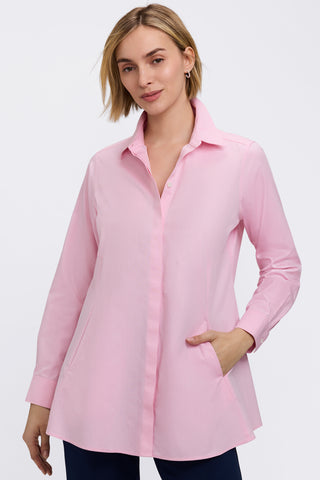 Front view of a woman wearing the Cici No Iron Pinpoint Long Sleeve Tunic with her hand in one of the angled pockets #color_chambray pink