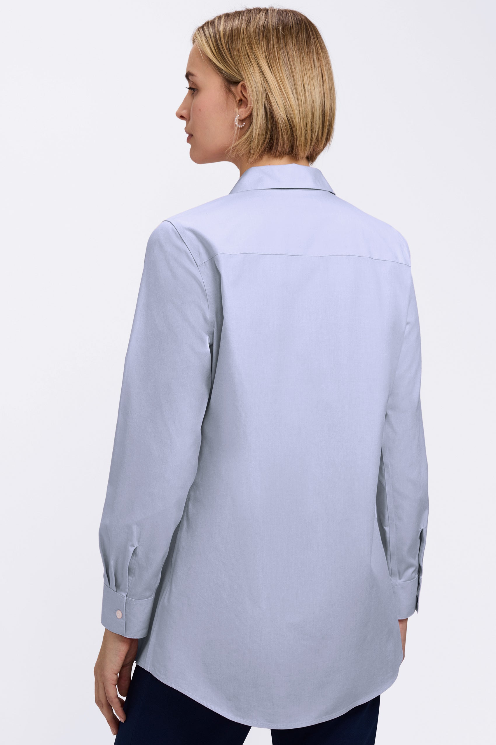 Back view of a woman wearing the Cici No Iron Pinpoint Long Sleeve Tunic #color_blue wave