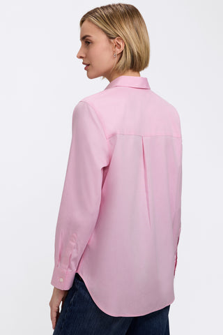 Angled back view of woman weraing the Boyfriend No Iron Pinpoint Long Sleeve Tunic #color_chambray pink