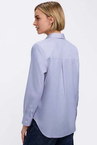 Angled back view of woman wearing the Boyfriend No Iron Pinpoint Long Sleeve Tunic #color_blue wave