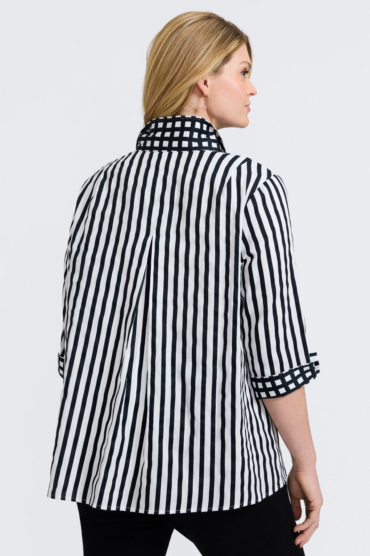 Agnes shirt with black stripes and gingham border, styled on a plus-size model for modern structure and classic charm.