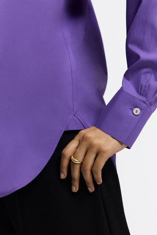 Close up view on the cuff of the Meghan No Iron Pinpoint Long Sleeve Shirt worn by a woman with her hand on her hip #color_royal purple