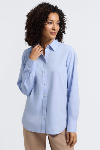 Front view of a woman wearing the Meghan No Iron Pinpoint Long Sleeve Shirt with her hand touching the collar of the shirt #color_blue wave