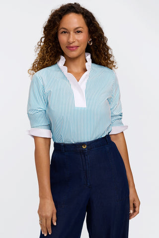 Model wearing the pinpoint striped 3/4 sleeve shirt tucked into a pair of jeans  with sleeves pushed up #color_capri pinpoint stripe