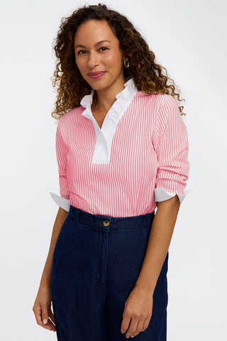 Model wearing pinpoint striped popover shirt tucked into a pair of jeans and sleeves pushed up #color_coral reef pinpoint stripe