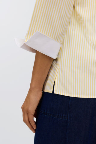 Close up of folded crisp white 3/4 sleeve arm cuff #color_lemon pinpoint stripe