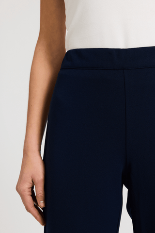 Close up front view of one side of the pants flattering waistband #color_navy