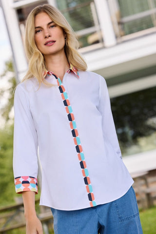 Angled front view of model wearing the Luna Retro Dot 3/4 Sleeve Shirt with a pair of jeans with an outdoor background