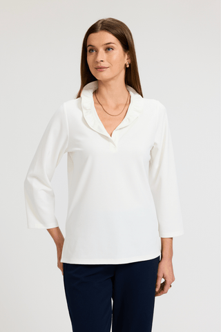 Front view of a woman wearing the Tammy Knit Crepe 3/4 Sleeve Popover Shirt with navy pants #color_ecru